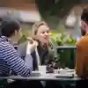 People sit eating outside Canham Turner surrounded by green hedges