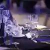 A close up of glasses and dinnerware at a set table