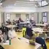 Groups of people in discussion around tables in a modern meeting space