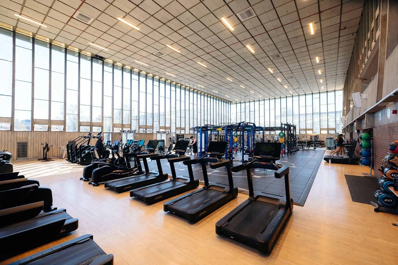 A fully equipped gym with large windows