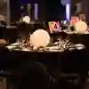 A close up of a set table with a large spherical glowing light in the middle