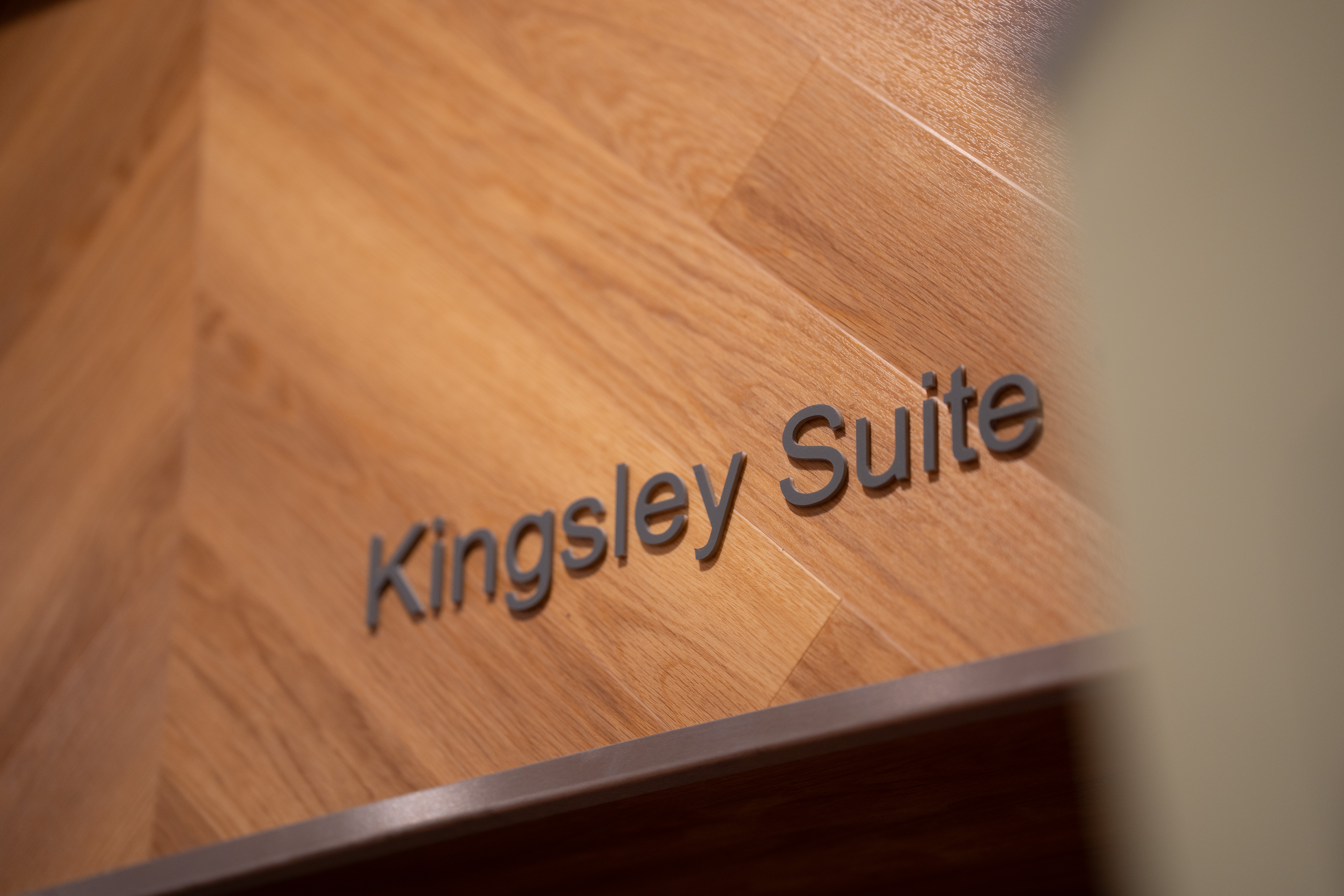 A close up of a sign saying 'Kingsley Suite'