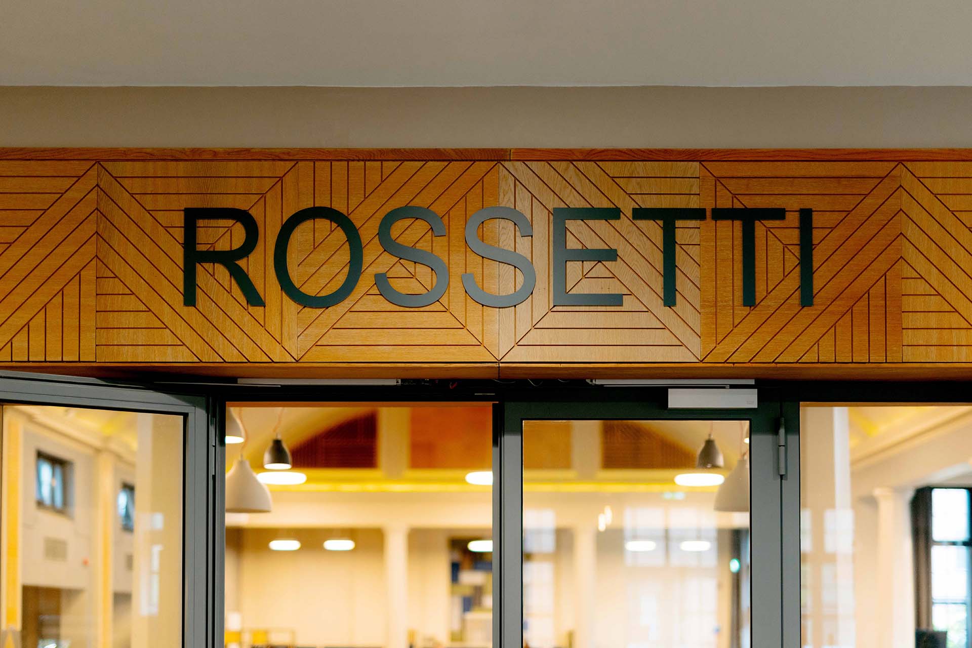 A close up of the word 'Rossetti' over the doors to the dining hall
