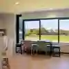 Table and chairs by a large kitchen window overlooking the playing field in The Courtyard.