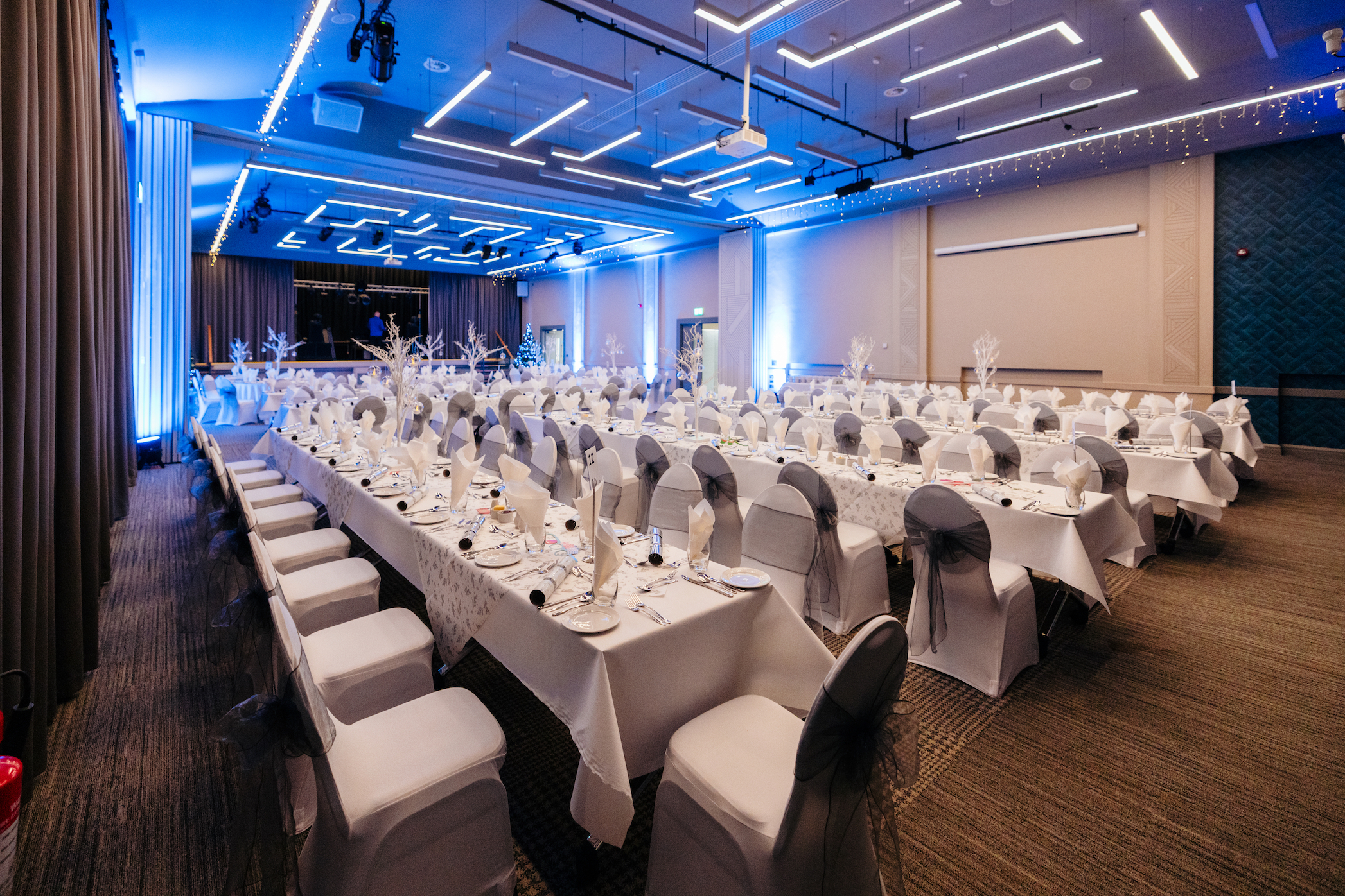 A view of long banquet tables set up in the Kingsley Suite