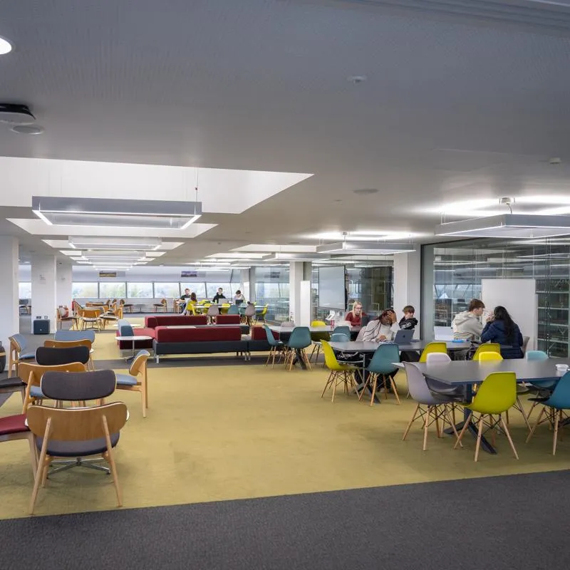 A large open plan space with furniture in various configurations for individual work, group activities and presentations