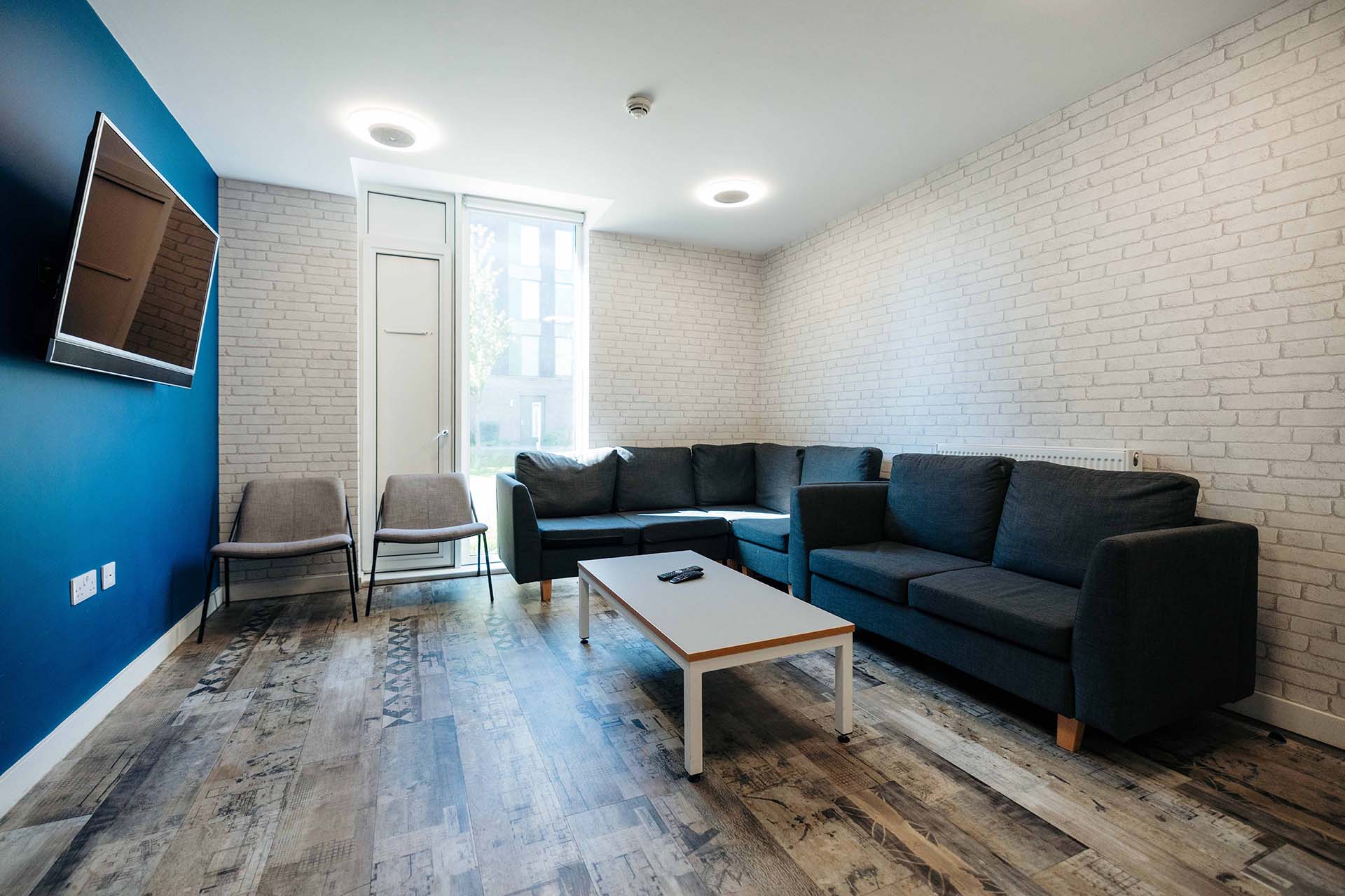 Communal living area in Westfield Court with large sofa and TV