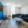 Communal living area in Westfield Court with large sofa and TV
